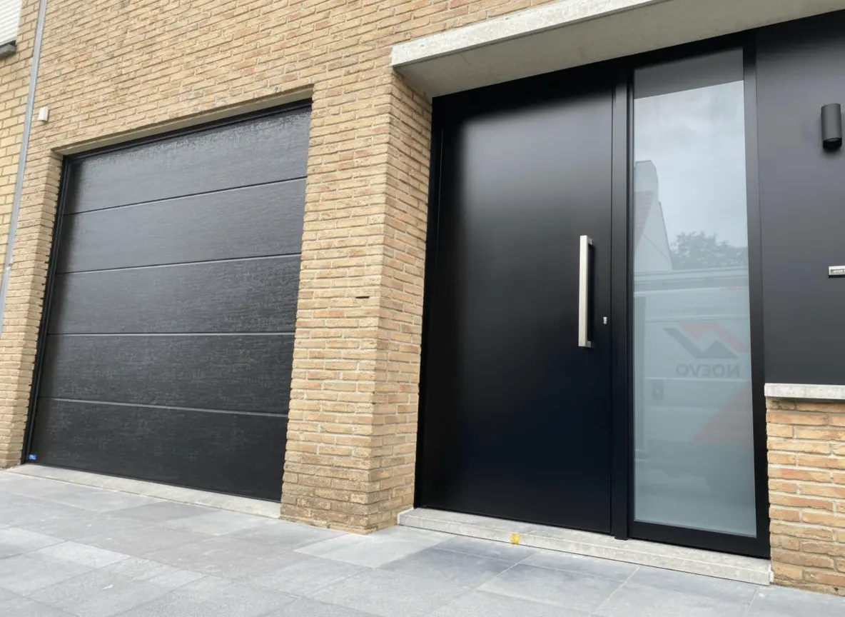 Dezelfde garagepoort en buitendeur na herlakken in donkergrijs
